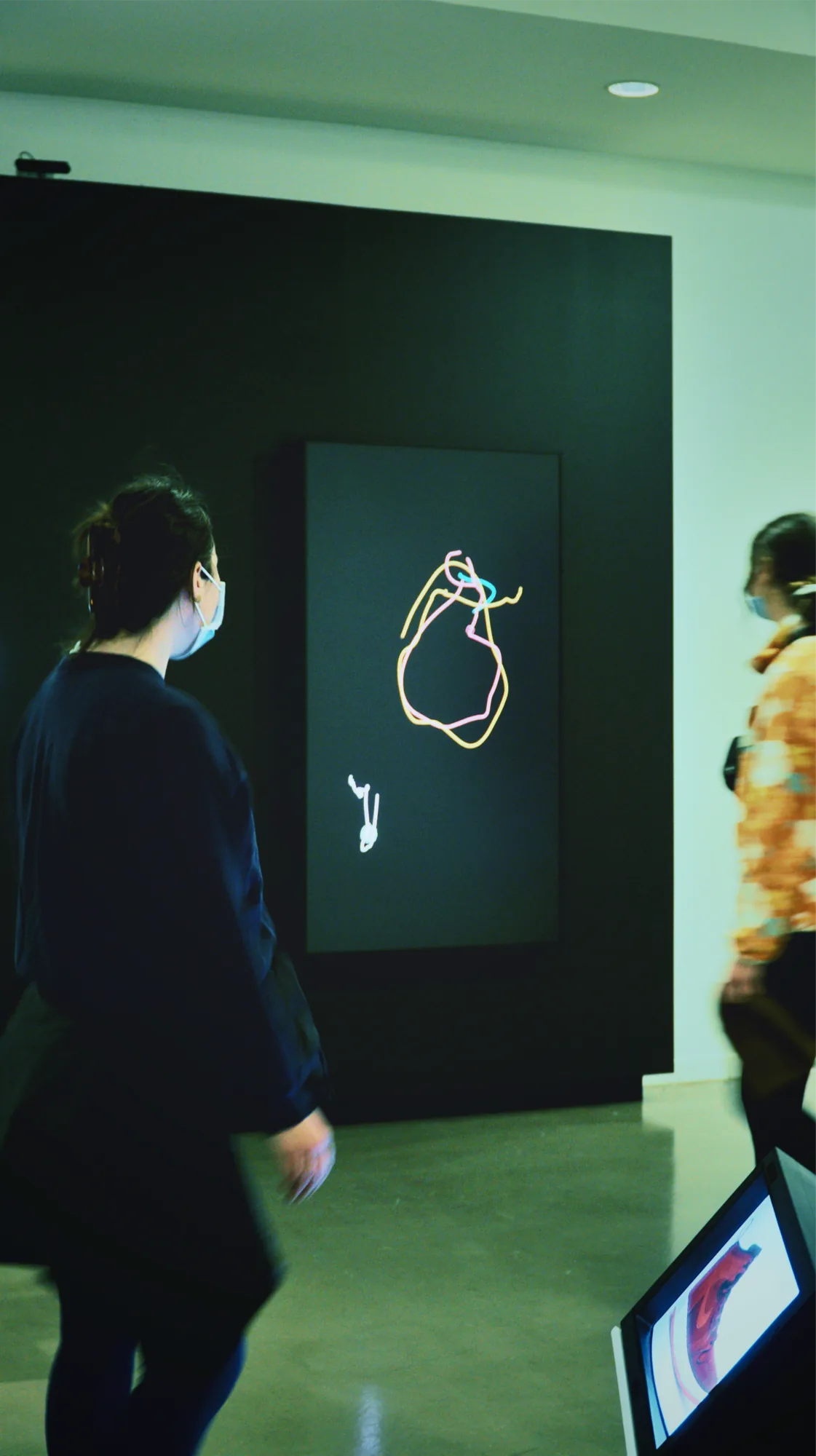 A visitor watching the installation in the gallery
